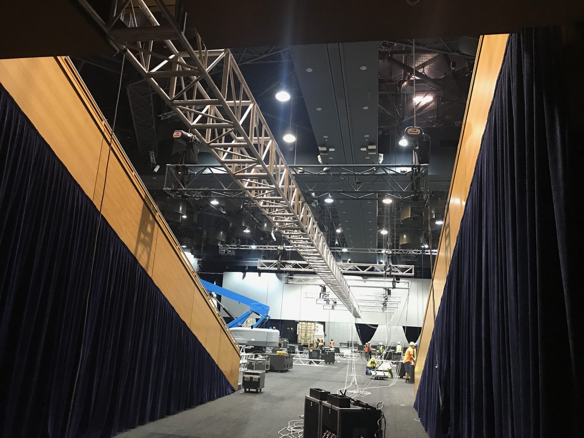 Tall drape wings either side of a lighting truss during an event load-in