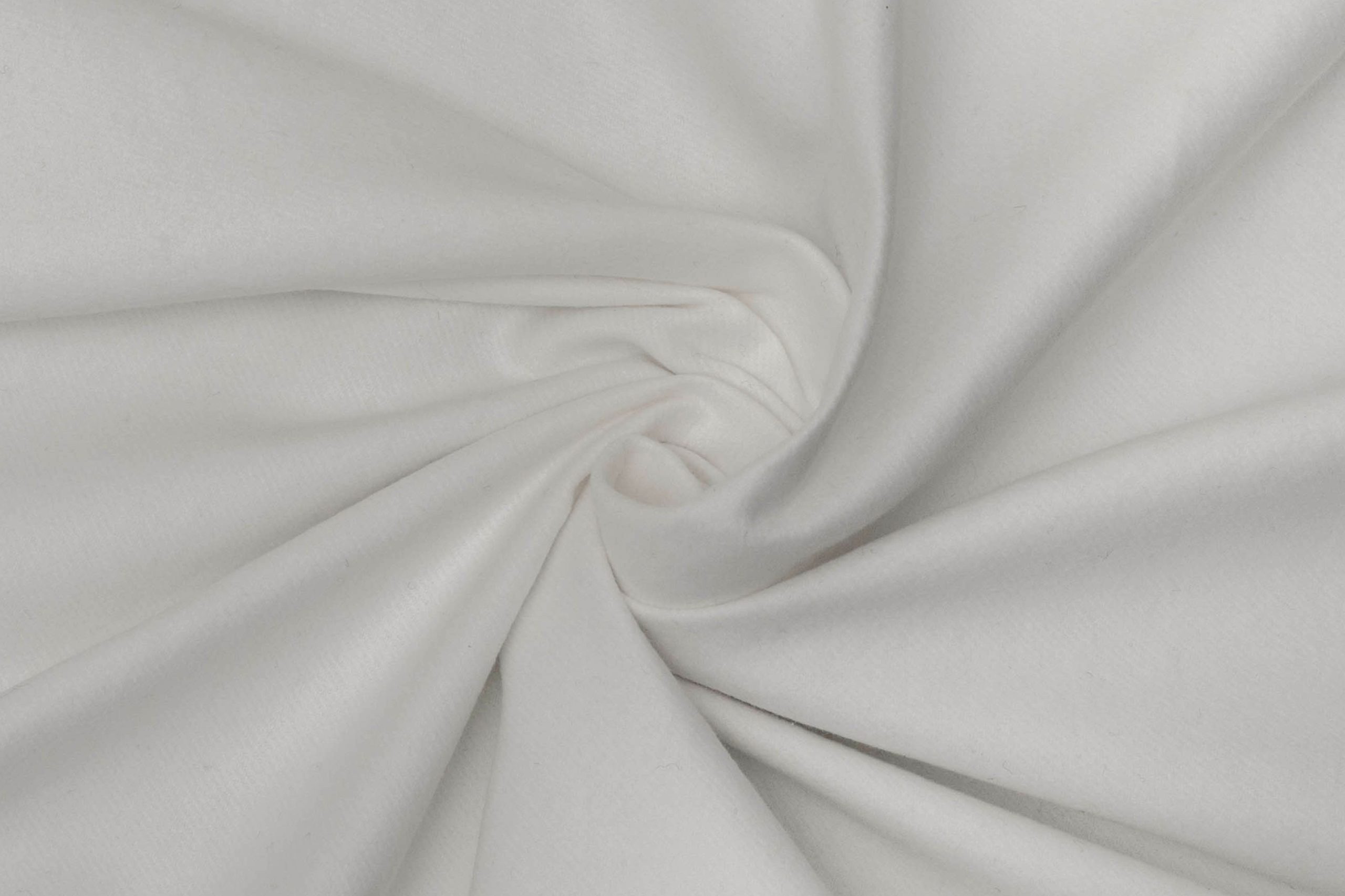 White stage molton gathered in a soft swirl, photographed in true colour