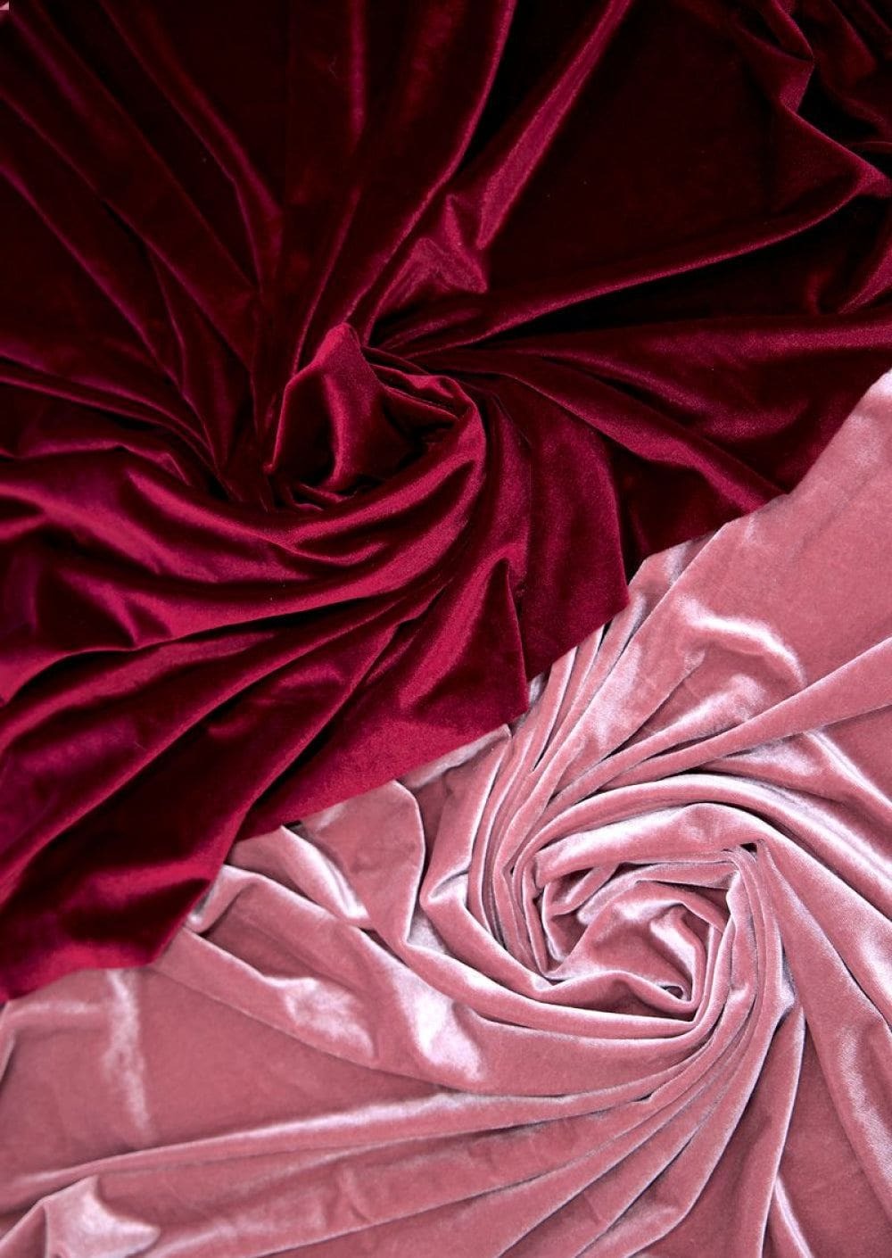 Red and pink velvet velour gathered in heavy folds, photographed in true colour